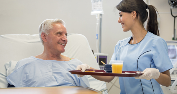 Healthcare2 Nurse Serving Food in a Hospital